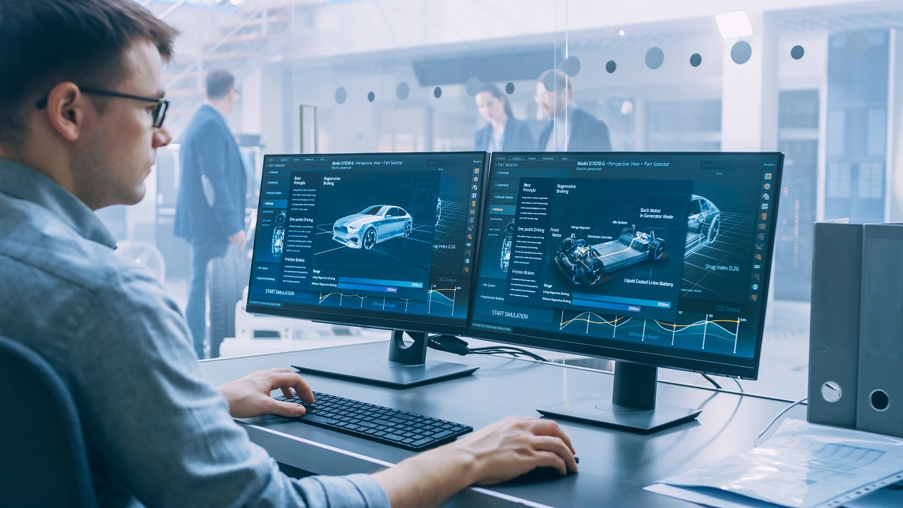 engineer looking at car models onscreen